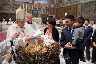 Pope Francis baptizes an infant Jan. 7 in the Vatican&#039;s Sistine Chapel. The Pope baptized 34 children during the celebration on the feast of the Baptism of the Lord.
