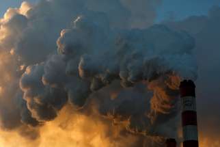Smoke and steam billow from a coal plant in Belchatow, Poland, Nov. 28, 2018.