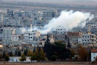 A view shows smoke rising Nov. 20 from a Kobani, Syria, neighborhood damaged by fighting between Islamic State militants and Kurdish forces. The Chaldean Catholic patriarch has appealed to moderate Muslims to more forcefully oppose actions of Islamic Sta te militants.