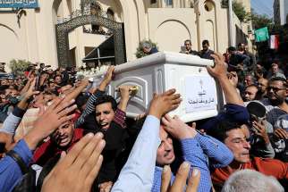 Egyptian Christians carry the casket of a victim during a Nov. 3 funeral Mass outside Prince Tadros Orthodox Church in Minya for a group of pilgrims killed by gunmen as they headed to a monastery Nov. 2.