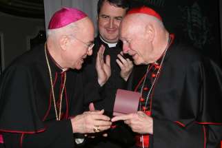  Archbishop Carlo Maria Vigano, then nuncio to the United States, congratulates then-Cardinal Theodore E. McCarrick of Washington at a gala dinner sponsored by the Pontifical Missions Societies in New York in May 2012.