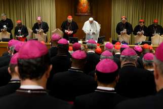 Pope Francis and prelates pray at the start of a session of the Synod of Bishops on young people, the faith and vocational discernment at the Vatican Oct. 11. 