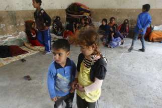 Displaced Iraqi children stand in a classroom of a school used as a shelter in the city of Ramadi April 11.