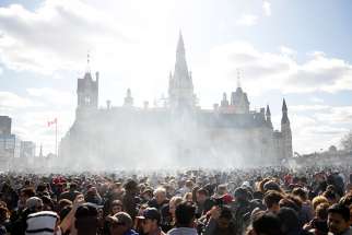 Smoke rises during the annual marijuana rally on Parliament Hill in Ottawa, Ontario, April 20, 2018.