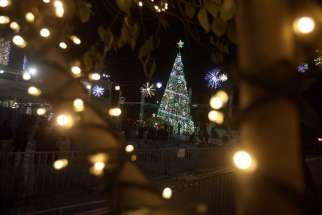 People attend the lighting of the Christmas tree on Manger Square in Bethlehem, West Bank, Dec. 5.