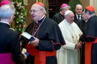 Pope Francis greets prelates during his annual pre-Christmas meeting with top officials of the Roman Curia and Vatican City State and with cardinals living in Rome in the Clementine Hall Dec. 21 at the Vatican.