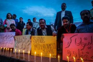 Pakistani Christian minority and civil society activists light candles at a 2014 protest in Karachi, Pakistan, against the killing of a Christian couple accused of blasphemy. Supporters of Pakistan’s blasphemy law were stopped Jan. 4 from holding a rally.