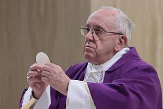  Pope Francis elevates the Eucharist as he celebrates morning Mass in the chapel of the Domus Sanctae Marthae at the Vatican March 12. In his homily, the pope said true Christians take risks to constantly seek out Christ.