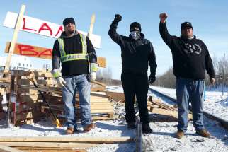 Supporters of the Wet’suwet’en Nation’s hereditary chiefs gesture as they camp at a railway blockade near Edmonton last month, part of protests against British Columbia’s Coastal GasLink pipeline.