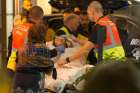 Paramedics rush a young woman to a waiting ambulance July 14 as they evacuate victims from the scene where a truck crashed into the crowd during the Bastille Day celebrations in Nice, France. More than 80 people were killed and the death toll was rising.