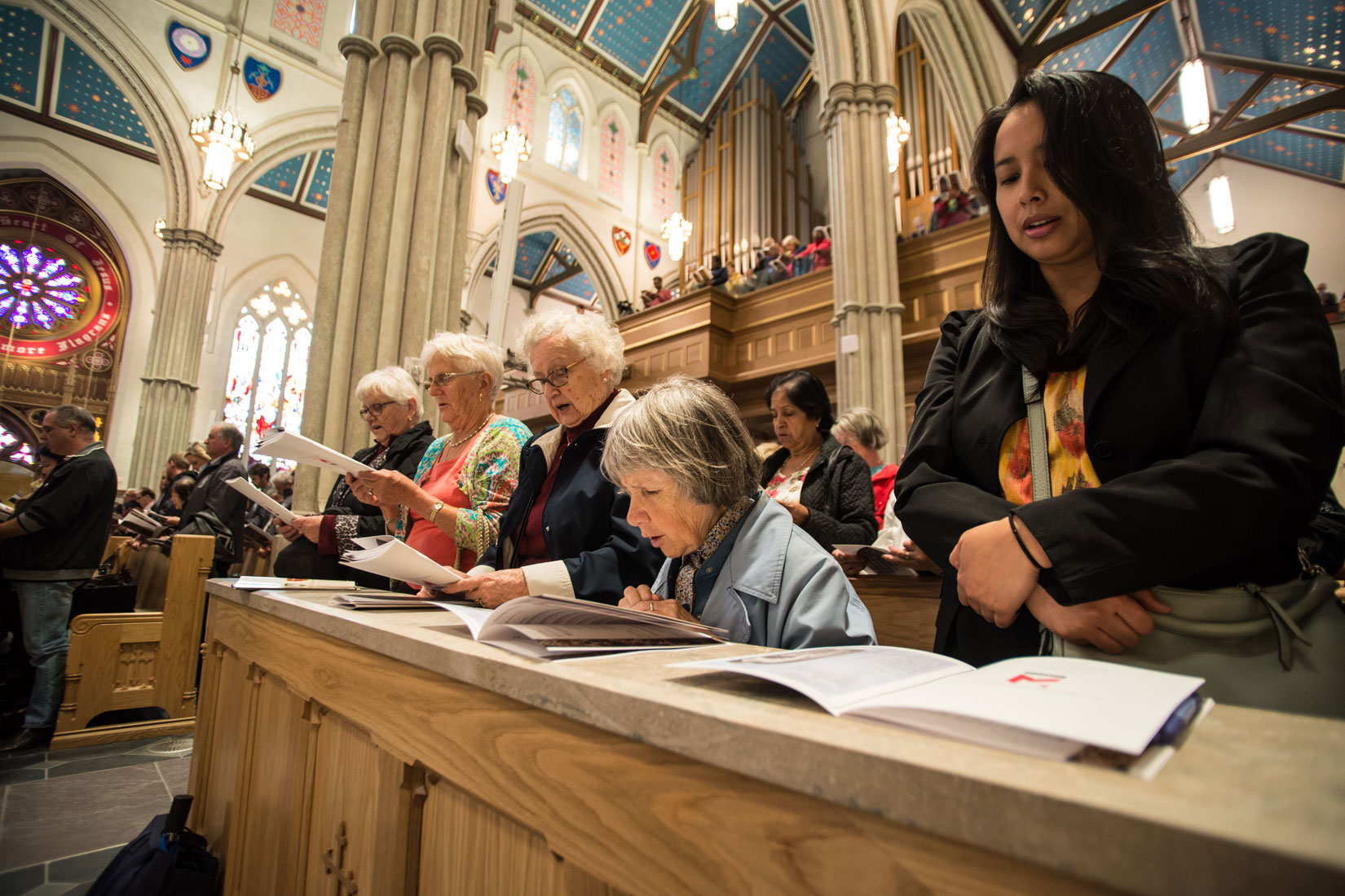 Women praying at the workers’ thanksgiving Mass at St. Michael’s Cathedral Sept. 30. (Photo by Michael Swan)