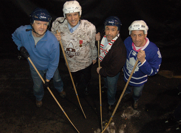 Showing they're just as photogenic as the students, St. Luke's gym teacher Andian Olsthoorn, trustee Frank D'Amico, TDCSB head office's Karmen Giambattist and Sam Dingillow, also from head office, strike a classic hockey stance before stepping on the ice for the ten shot challenge.