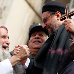 A Christian cleric clasps hands with a Muslim sheik during a rally to demonstrate unity between Muslims and Christians in Tahrir Square in Cairo, Egypt, March 11. The rally took place after recent sectarian clashes left 13 people dead. (CNS photo/Mohamed Abd El-Ghany, Reuters)