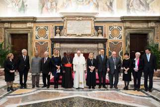Pope Francis poses with Nobel Peace Prize laureates during an audience with attendees at a conference on building a world free of nuclear weapons, at the Vatican Nov. 10. Also pictured is Cardinal Peter Turkson, prefect of the Vatican&#039;s Dicastery for Promoting Integral Human Development.