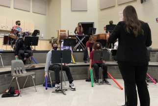 Kait Tappenden conducts St. Mary’s College music students, including the “Boomwhackers.”