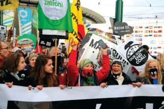 Protesters march outside the venue of the UN climate change conference in Katowice, Poland. 