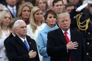 U.S Vice President Mike Pence and President Donald Trump stand for the singing of the national anthem after Trump&#039;s swearing-in as the country&#039;s 45th president at the U.S. Capitol in Washington.