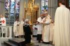 Cardinal-elect Francis Leo invests Gordon Lawson into the Order of the Holy Sepulchre on Oct. 27.