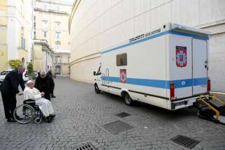 Pope Francis, accompanied by Cardinal Konrad Krajewski, prefect of the Dicastery for the Service of Charity, blesses the mobile hospital Dec. 18, 2024, at the Vatican. On the same day Cardinal Krajewski left for Ukraine, driving the mobile hospital from Rome to Lviv, Ukraine.