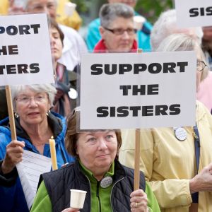 Jenner Mathiasen, center, of Seattle takes part in a vigil outside St. James Cathedral in Seattle May 8 to support sisters against the Vatican&#039;s call for a reform of the Leadership Conference of Women Religious. The LCWR, in a June 1 statement responding to the Vatican&#039;s critical assessment of its organization, acknowledged the messages and signs of support received from Catholics and non-Catholics around the world.