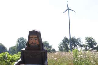 A wooden figure of St. Francis of Assisi is perched in the yard of the energy-efficient straw-bale house built by a Catholic religious order in Ohio. Pope Francis’ second encyclical on the environment is called “Laudato Si” and is named after a St. Francis of Assisi prayer. Pope Francis calls everyone to be a steward of the Earth.