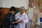 Rosella Kinsohameg with Fr. Doug McCarthy at her grandson Tanner’s First Communion.