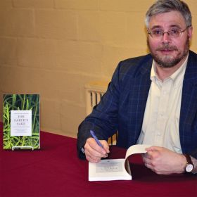 Stephen Scharper signs a copy of his latest book, For Earth’s Sake, after giving an hour-long lecture on the role of religious imagination in dealing with the environmental crisis.