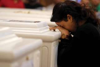  A woman mourns during a Nov. 3 funeral Mass at Prince Tadros Orthodox Church in Minya, Egypt, for a group of Christian pilgrims killed by gunmen as they headed to a monastery Nov. 2. 