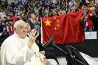 Pope Francis waves as people behind him raise a Chinese flag before the Pope’s Mass in Steppe Arena in Ulaanbaatar, Mongolia, Sept. 3, 2023. Critics say the Vatican’s diplomatic accord with China gives the communist regime the upper hand.