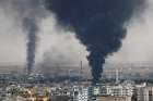 Smoke rises over the Syrian city of Ras al Ain Oct. 16, 2019, as seen from the Turkish border city of Ceylanpinar. Humanitarian concerns are growing as people caught in the crosshairs of the Turkish incursion into northeastern Syria try to flee for safety, and groups are scrambling to aid them.