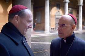 Ralph Fiennes as Cardinal Lawrence and Stanley Tucci star in a scene from the movie Conclave.