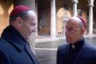 Ralph Fiennes as Cardinal Lawrence and Stanley Tucci star in a scene from the movie Conclave.