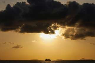 A ship sails on the Gulf of Thailand during sunset at Ko Samui March 3, 2020. Saying he wanted to renew his &quot;urgent call to respond to the ecological crisis,&quot; Pope Francis asked Catholics around the globe to participate in the international observance of &quot;Laudato Si&#039; Week&quot; May 16-24.