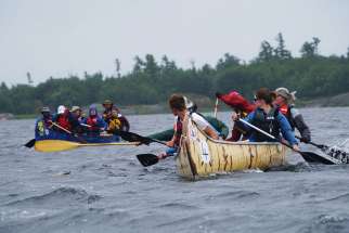 A couple of the crews engaged in a playful mini-race as the Canadian Canoe Pilgrimage got underway July 21 in Midland, Ont., the start of a 900 km journey.