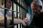 Father Tom McNally prays with death-row inmate Eric Wrinkles at Indiana State Prison in Michigan City in this Dec. 18, 2008, file photo. Wrinkles, who experienced a religious awakening in prison, was executed for triple-murderer Dec. 11, 2009. In Texas, a group of nearly 200 faith leaders, including 18 Catholics, signed a statement sent to the Texas Department of Criminal Justice July 23, 2019, asking the department to change its policy banning prison chaplains from execution chambers.