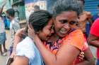 People in Colombo, Sri Lanka, react April 22, 2019, as military attend a suspected van containing explosives. Sri Lankan officials reported 290 confirmed deaths from the eight blasts at churches and hotels in three cities the previous day. 