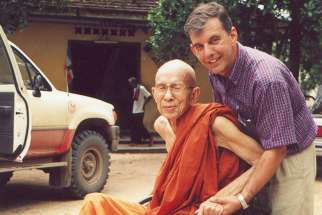 Monsignor Figaredo and a Buddhist monk in a wheelchair in an undated photo in Phnom Penh, Cambodia. 
