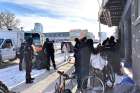 Edmonton Police cart off tarps and belongings of homeless people outside the downtown Bissell Centre.