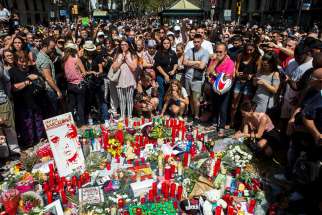 People pay tribute in Barcelona, Spain, Aug. 18, to victims on the site of a deadly van attack the previous day.