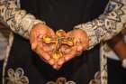 Peace Samuel holds a crucifix given as a gift from the Office of Refugees, Archdiocese of Toronto.