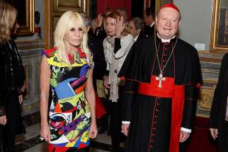 Italian fashioner designer Donatella Versace and Cardinal Gianfranco Ravasi, president of the Pontifical Council for Culture, arrive for a press presentation for the exhibit, &quot;Heavenly Bodies: Fashion and the Catholic Imagination,&quot; at Galleria Colonna in Rome Feb. 26. 