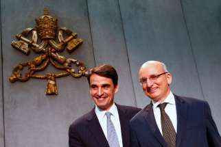 Jean-Baptise de Franssu, the new president of the Vatican bank, and outgoing president Ernst Von Freyberg pose during a news conference at the Vatican July 9.