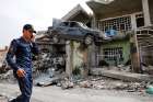 An Iraqi Federal Police member walks next to a destroyed house after clashes with Islamic State fighters in Mosul, Iraq, April 28.