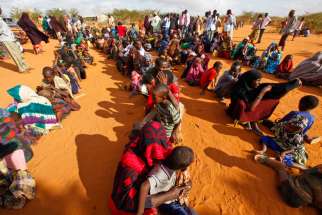Refugees who fled the famine in Somalia wait in a reception area in 2011 at a camp in Dadaab, Kenya. Catholic Charities of St. Paul-Minneapolis are helping settle down a Somali refugee family. 