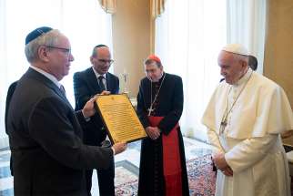 A representative of the American Jewish Committee gives Pope Francis a certificate March 8, 2019, certifying that a grapevine in Israel has been dedicated to him and promising that each year he will receive a bottle of wine produced with the vine&#039;s grapes. 
