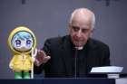 Archbishop Rino Fisichella, pro-prefect of the Dicastery for Evangelization&#039;s section for new evangelization and the chief organizer of the Holy Year 2025, presents the official mascot of the Jubilee Year during a news conference at the Vatican Oct. 28, 2024.