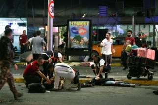 Paramedics help people outside Istanbul&#039;s Ataturk Airport following a June 28 suicide attack. The bombings killed dozens and wounded more than 200 as Turkish officials blamed the carnage at the international terminal on three suspected Islamic State group militants.