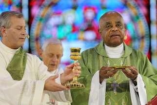 Atlanta Archbishop Wilton D. Gregory, right, Concelebrates Mass during the &quot;Convocation of Catholic Leaders: The Joy of the Gospel in America&quot; July 2 in Orlando, Fla.  Bishops should look at ways to help verify and guarantee the validity and worthiness of the bread and wine used for the celebration of the Eucharist, the Vatican said in a recent document.