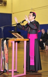 Toronto Auxiliary Bishop Vincent Nguyen gives a final blessing to the students and staff at Pope John Paul II Catholic Secondary School in Scarborough during a beatification celebration May 2.