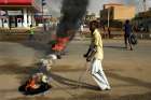 A man in Khartoum, Sudan, walks past a barricade June 3, 2019. Protesters there demand that the country&#039;s Transitional Military Council hand over power to civilians.